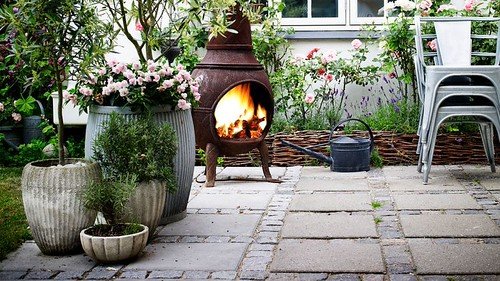 Paved garden patio with outdoor fireplace